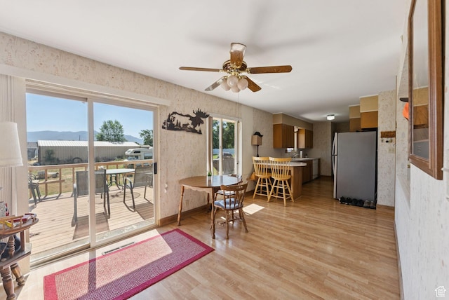 2690 N 4275 W, Plain City, UT 84404 - dining space with wallpapered walls, light wood-type flooring, and ceiling fan
