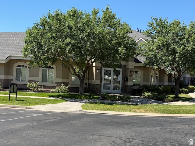 1616 W Vivante Way Unit A3, West Valley City, UT 84119 - view of property hidden behind natural elements with stucco siding and stone siding