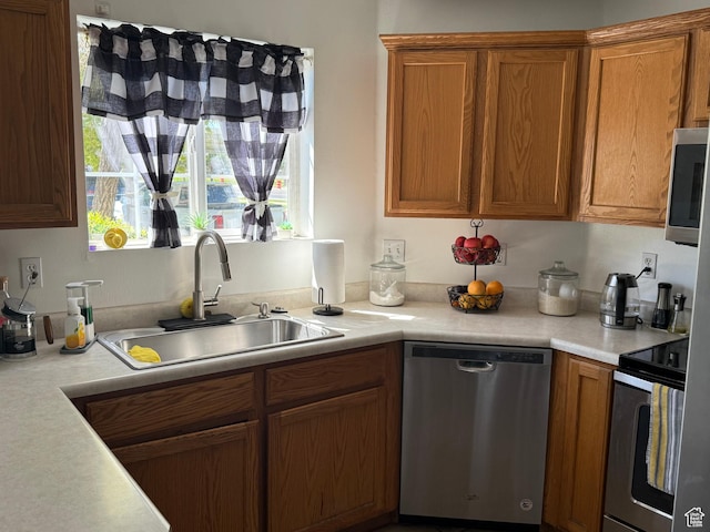 1616 W Vivante Way Unit A3, West Valley City, UT 84119 - kitchen featuring stainless steel appliances, light countertops, and brown cabinetry