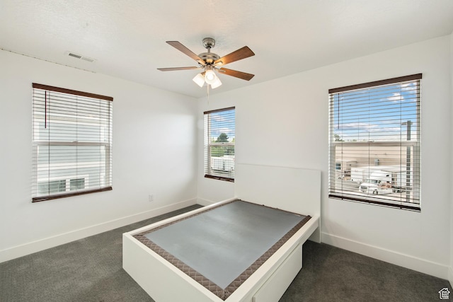 3902 W Pilton Ct, Taylorsville, UT 84129 - unfurnished bedroom featuring dark carpet and ceiling fan