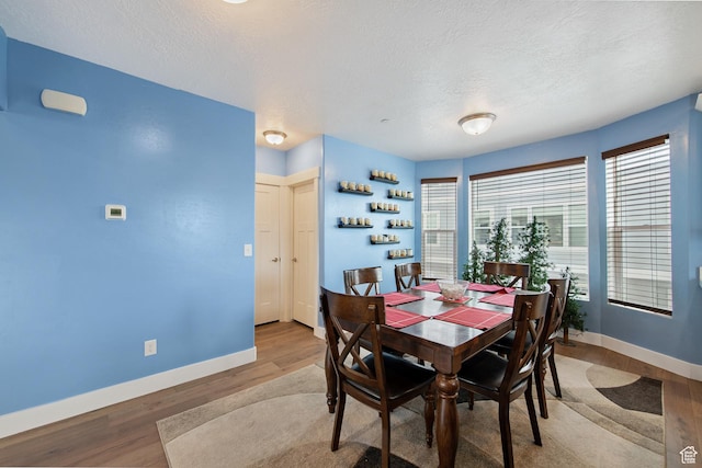 3902 W Pilton Ct, Taylorsville, UT 84129 - dining area with wood finished floors and a textured ceiling