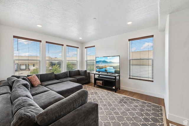 3902 W Pilton Ct, Taylorsville, UT 84129 - living room featuring recessed lighting, wood finished floors, healthy amount of natural light, and a textured ceiling
