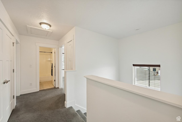 3902 W Pilton Ct, Taylorsville, UT 84129 - hallway featuring dark carpet, attic access, and an upstairs landing