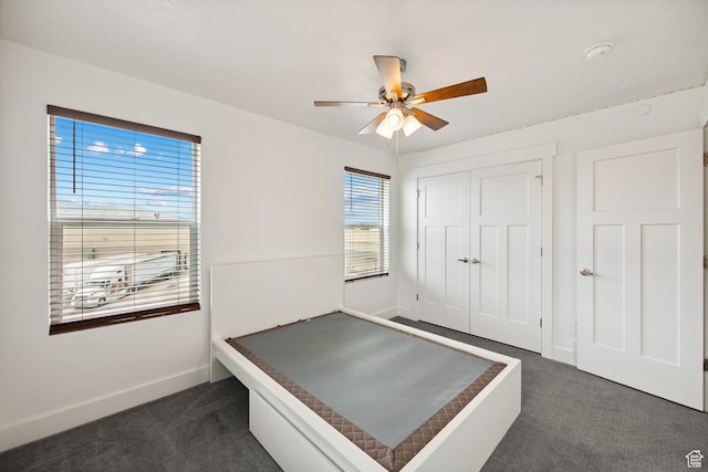 3902 W Pilton Ct, Taylorsville, UT 84129 - unfurnished bedroom with dark carpet, a closet, and ceiling fan