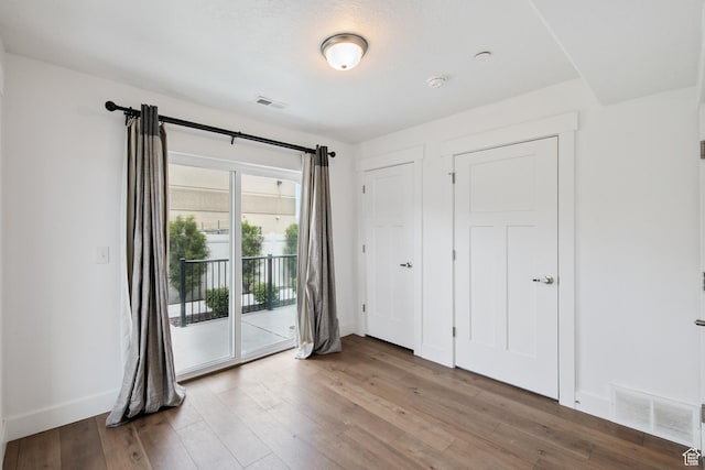 3902 W Pilton Ct, Taylorsville, UT 84129 - unfurnished bedroom featuring access to outside and wood finished floors