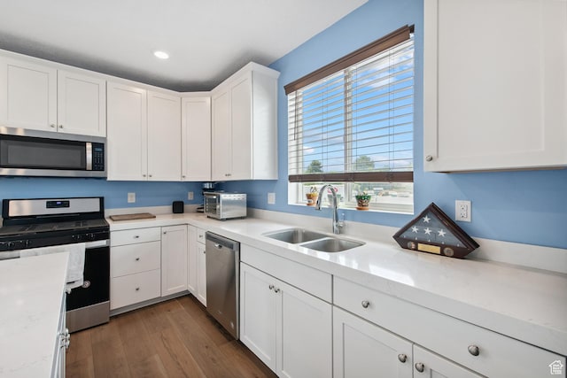3902 W Pilton Ct, Taylorsville, UT 84129 - kitchen featuring appliances with stainless steel finishes, dark wood-style floors, white cabinets, and recessed lighting