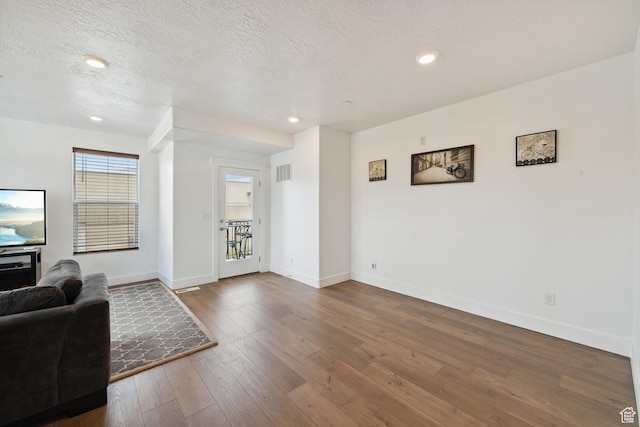 3902 W Pilton Ct, Taylorsville, UT 84129 - living area with hardwood / wood-style floors, a textured ceiling, and recessed lighting