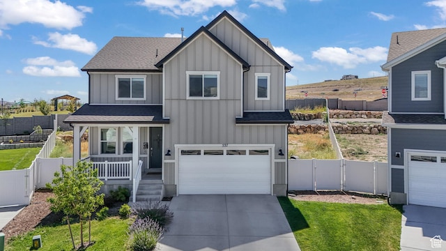 537 W Flora Dr, Saratoga Springs, UT 84045 - view of front of property with board and batten siding, covered porch, roof with shingles, driveway, and a garage
