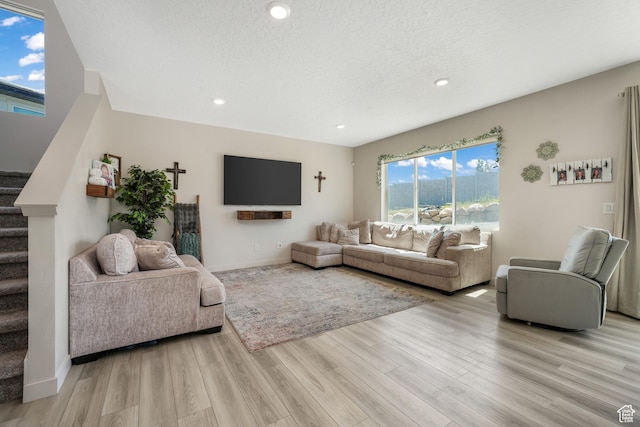 537 W Flora Dr, Saratoga Springs, UT 84045 - living room with stairs, light wood-style floors, recessed lighting, and a textured ceiling