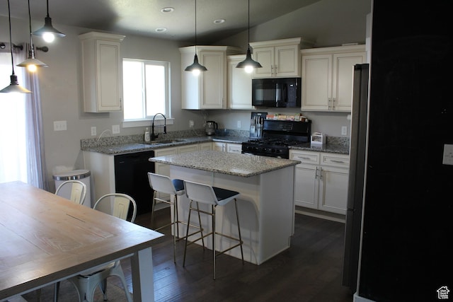 2359 E Prairie Ln, Eagle Mountain, UT 84005 - kitchen with black appliances, a center island, recessed lighting, dark wood-type flooring, and white cabinets
