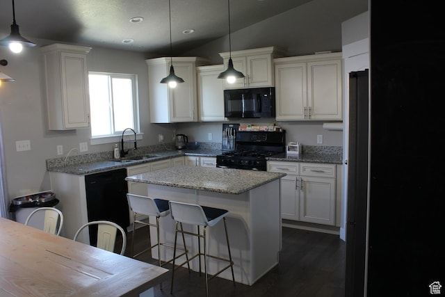 2359 E Prairie Ln, Eagle Mountain, UT 84005 - kitchen featuring black appliances, a center island, dark wood finished floors, a breakfast bar, and recessed lighting