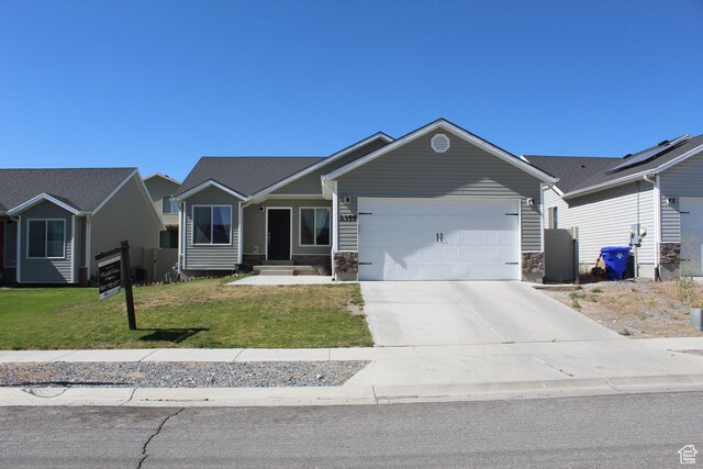 2359 E Prairie Ln, Eagle Mountain, UT 84005 - single story home featuring concrete driveway, an attached garage, a front yard, and stone siding