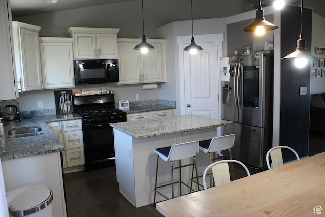 2359 E Prairie Ln, Eagle Mountain, UT 84005 - kitchen featuring black appliances, dark wood-type flooring, a kitchen island, light stone counters, and decorative light fixtures