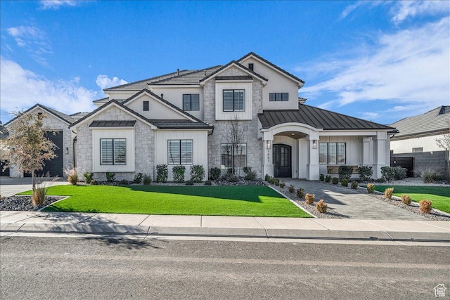 1597 W Belayer Dr, St George, UT 84770 - modern inspired farmhouse featuring a standing seam roof, stone siding, a front yard, and a metal roof