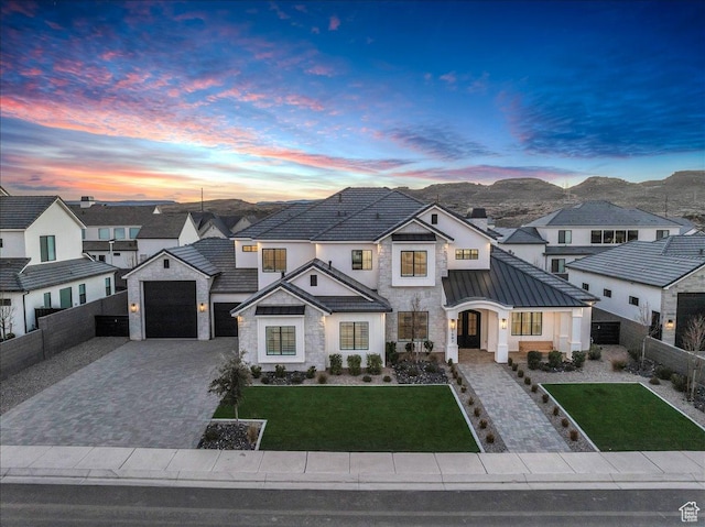1597 W Belayer Dr, St George, UT 84770 - french country home featuring stone siding, a standing seam roof, decorative driveway, a residential view, and a metal roof