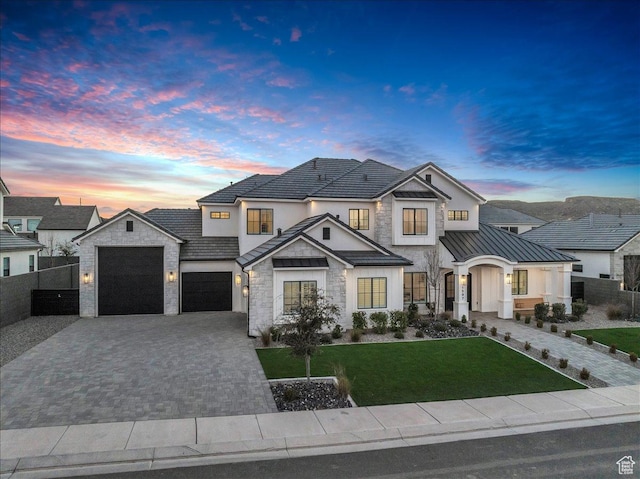 1597 W Belayer Dr, St George, UT 84770 - view of front of house featuring decorative driveway, stone siding, a standing seam roof, a garage, and a metal roof