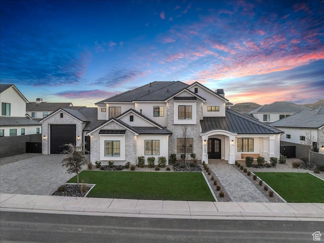 1597 W Belayer Dr, St George, UT 84770 - view of front facade with stone siding, a standing seam roof, decorative driveway, a metal roof, and a garage