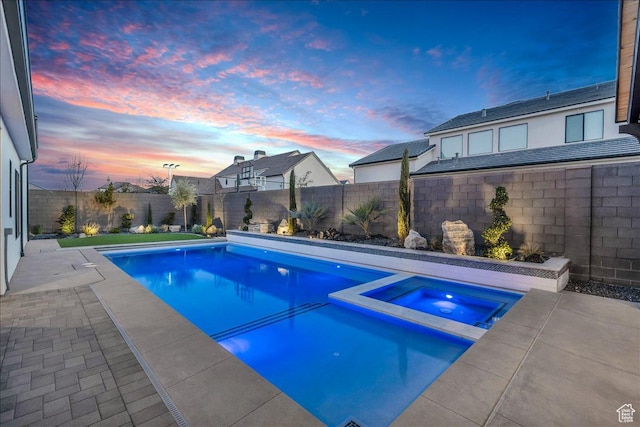 1597 W Belayer Dr, St George, UT 84770 - pool at dusk with a pool with connected hot tub, a fenced backyard, and a patio area