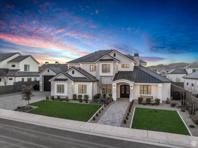 1597 W Belayer Dr, St George, UT 84770 - view of front of home with a standing seam roof, stone siding, french doors, and decorative driveway