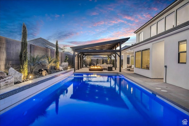 1597 W Belayer Dr, St George, UT 84770 - pool at dusk with an outdoor living space, a fenced backyard, a patio area, and a gazebo