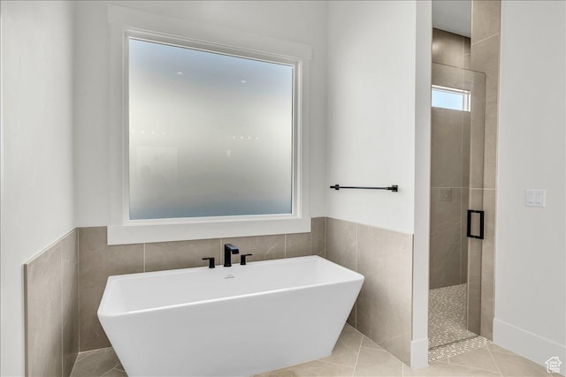 1597 W Belayer Dr, St George, UT 84770 - full bath featuring a freestanding bath, a stall shower, tile walls, tile patterned flooring, and wainscoting