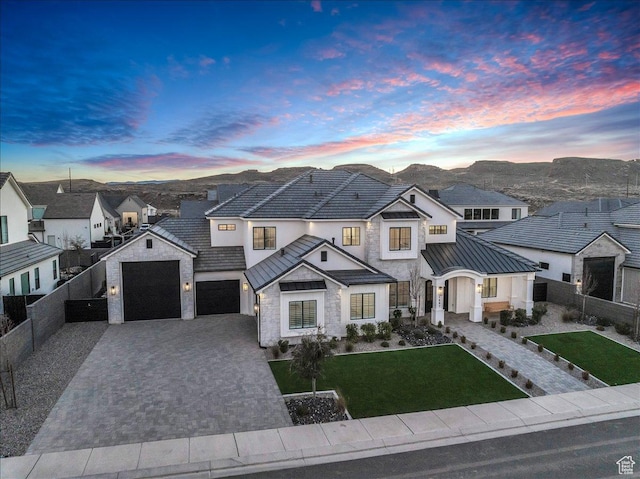 1597 W Belayer Dr, St George, UT 84770 - french country style house with stone siding, decorative driveway, a standing seam roof, a metal roof, and a residential view