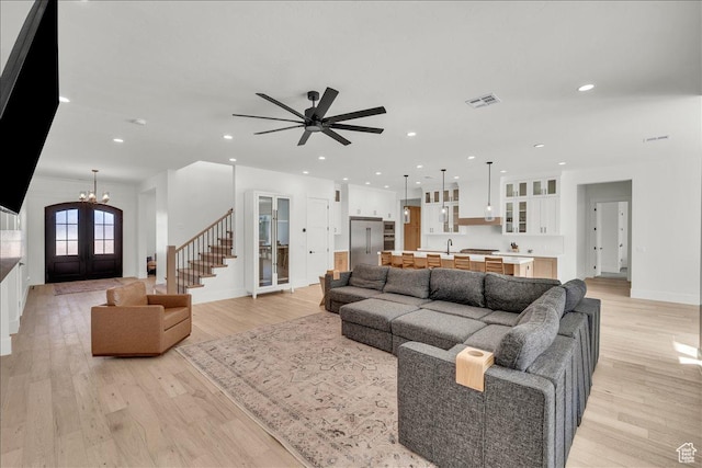 1597 W Belayer Dr, St George, UT 84770 - living area with light wood-type flooring, french doors, stairway, recessed lighting, and a chandelier