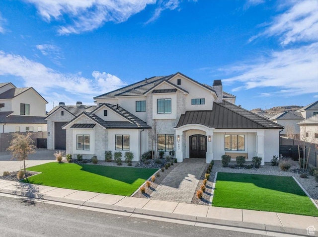 1597 W Belayer Dr, St George, UT 84770 - view of front facade with a standing seam roof, french doors, a chimney, decorative driveway, and stone siding