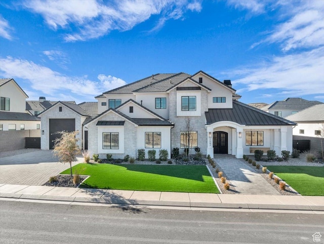 1597 W Belayer Dr, St George, UT 84770 - modern inspired farmhouse with a standing seam roof, a front yard, stone siding, driveway, and a metal roof