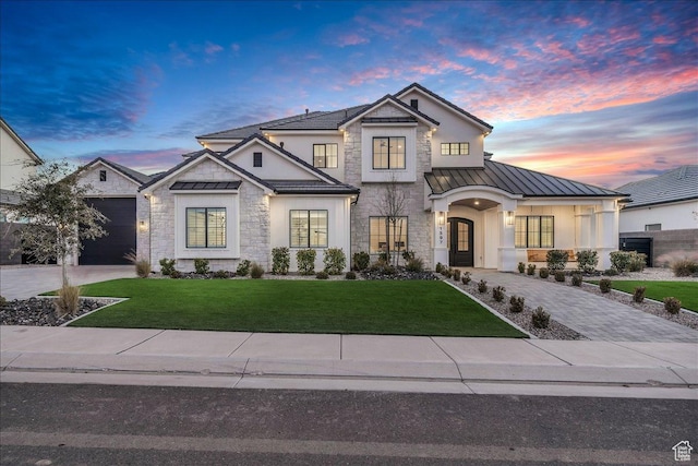 1597 W Belayer Dr, St George, UT 84770 - modern farmhouse with a standing seam roof, stone siding, driveway, and a front lawn