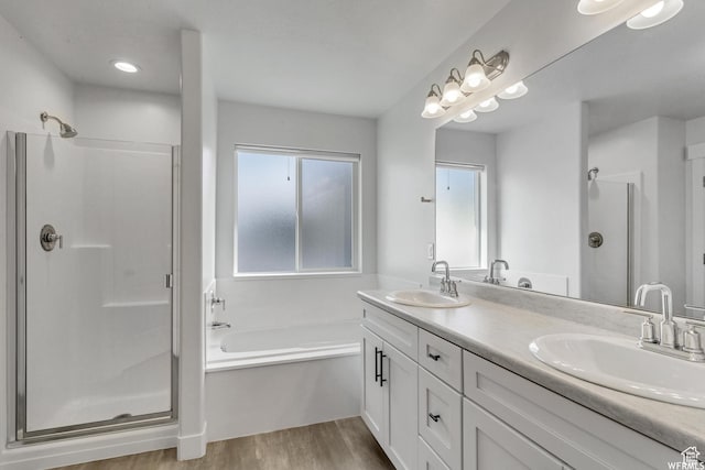 4273 W Watchmen Way, Herriman, UT 84096 - bathroom featuring a shower stall, wood finished floors, a bath, and double vanity