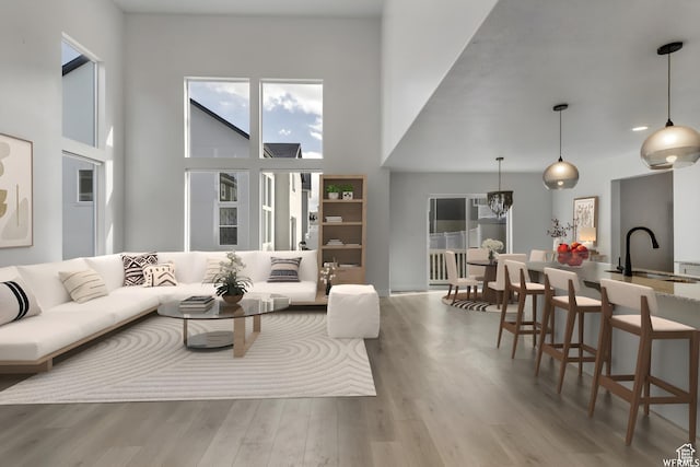 4273 W Watchmen Way, Herriman, UT 84096 - living area featuring a high ceiling, wood finished floors, and a chandelier