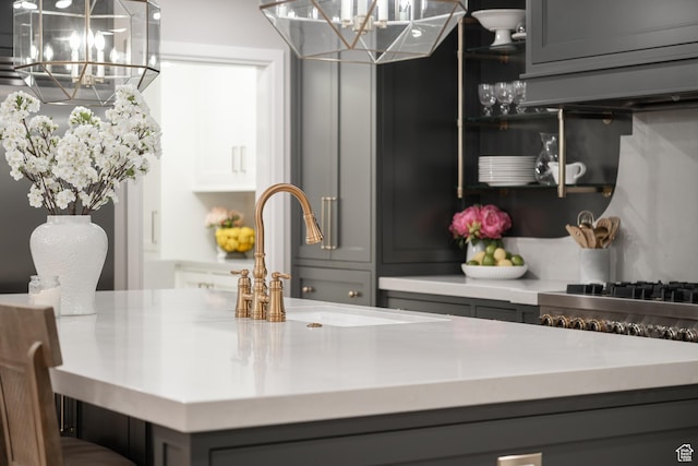 4605 S Ledgemont Dr E, Salt Lake City, UT 84124 - kitchen featuring a chandelier, gray cabinets, light countertops, and exhaust hood