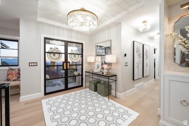 4605 S Ledgemont Dr E, Salt Lake City, UT 84124 - entryway featuring a chandelier, light wood finished floors, and a raised ceiling