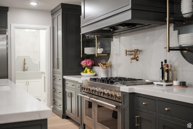 4605 S Ledgemont Dr E, Salt Lake City, UT 84124 - kitchen featuring premium appliances, light countertops, light wood-type flooring, and recessed lighting