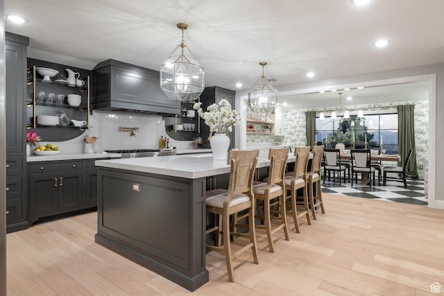 4605 S Ledgemont Dr E, Salt Lake City, UT 84124 - kitchen with custom range hood, light countertops, a center island, light wood-type flooring, and open shelves