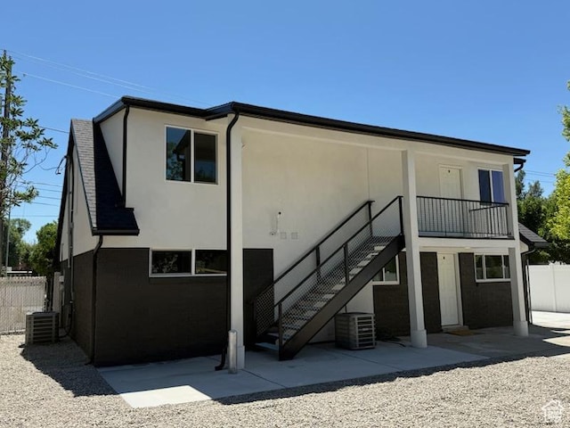 445 E Fort Union Blvd, Midvale, UT 84047 - back of house with stucco siding, a patio, and stairs