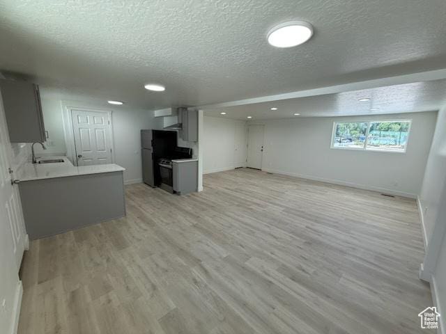 445 E Fort Union Blvd, Midvale, UT 84047 - unfurnished living room with a textured ceiling, light wood-type flooring, and recessed lighting