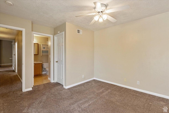 1218 W 1420 N, Orem, UT 84057 - unfurnished bedroom with dark carpet, a textured ceiling, connected bathroom, and a ceiling fan