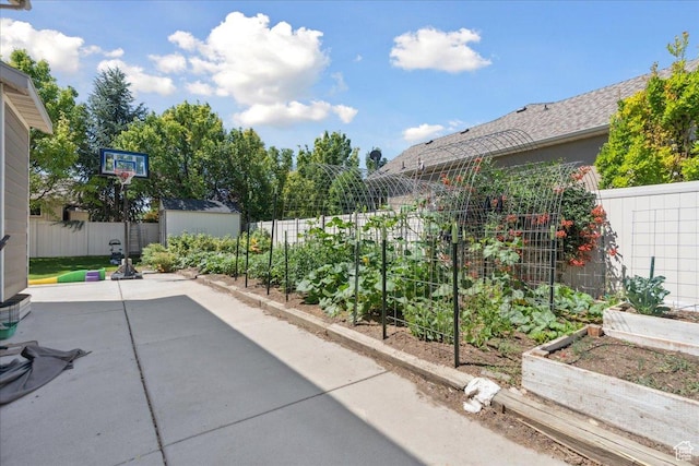 5719 W Boulder Creek Rd, West Jordan, UT 84081 - fenced backyard with a vegetable garden, a patio area, and a shed