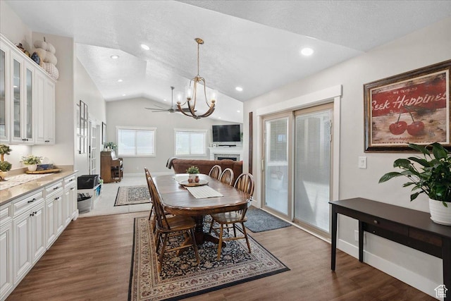 5719 W Boulder Creek Rd, West Jordan, UT 84081 - dining area featuring lofted ceiling, a chandelier, wood finished floors, a textured ceiling, and recessed lighting
