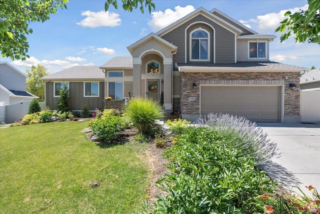 5719 W Boulder Creek Rd, West Jordan, UT 84081 - view of front of property with concrete driveway, a garage, and stone siding