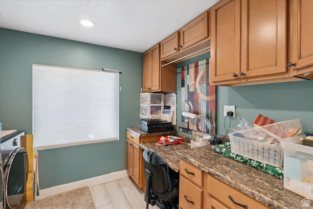 5719 W Boulder Creek Rd, West Jordan, UT 84081 - kitchen with built in study area, recessed lighting, brown cabinets, and dark stone countertops