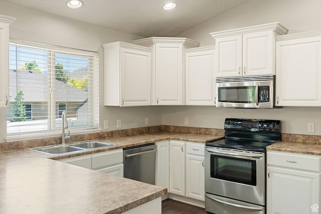 151 E 360 N, Providence, UT 84332 - kitchen featuring stainless steel appliances, white cabinetry, recessed lighting, vaulted ceiling, and dark wood-type flooring