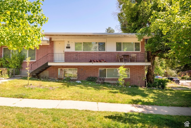 906 E Third Ave, Salt Lake City, UT 84103 - view of front of home with a front lawn, brick siding, and stairs
