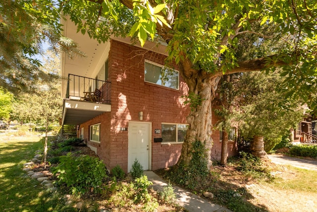 906 E Third Ave, Salt Lake City, UT 84103 - view of front of house featuring a balcony and brick siding