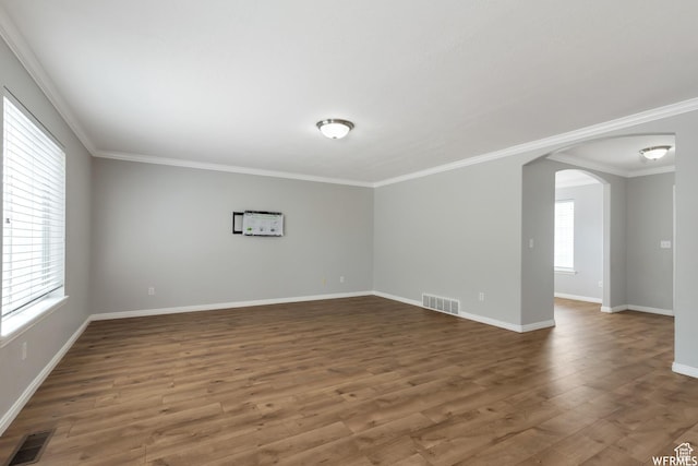 901 S Apple Grove Ln, Pleasant Grove, UT 84062 - unfurnished room featuring arched walkways, wood finished floors, and crown molding