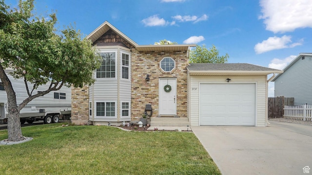 3737 S Washington Dr W, Magna, UT 84044 - view of front of property featuring an attached garage, concrete driveway, and brick siding