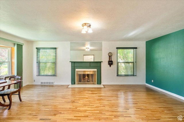 458 E 8800 S, Sandy, UT 84070 - living room featuring light wood-style flooring, a fireplace with flush hearth, and a textured ceiling