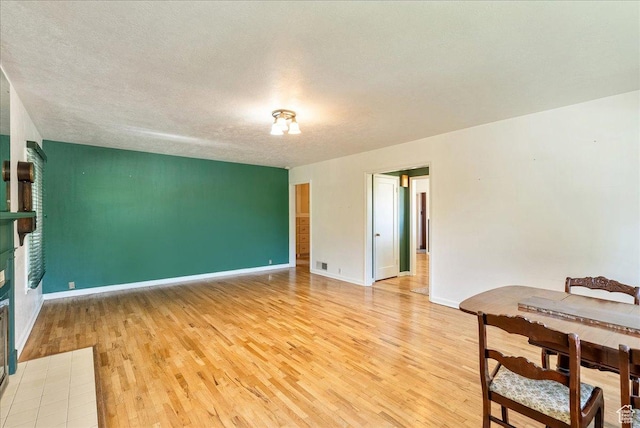 458 E 8800 S, Sandy, UT 84070 - unfurnished room featuring light wood-type flooring, a tile fireplace, and a textured ceiling